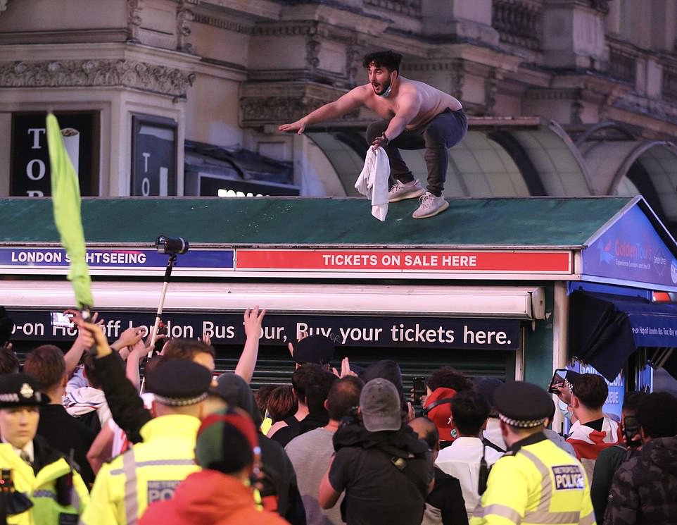 44841491-9738303-LONDON_An_England_fan_appears_to_prepare_to_dive_into_a_crowd_of-m-175_1625011789591.jpg