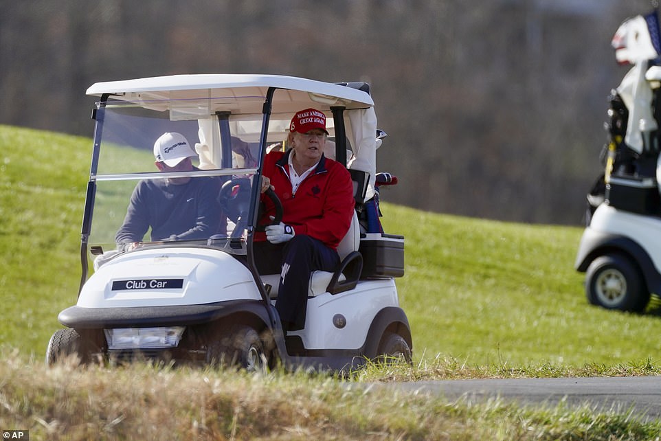 36208654-8996193-Trump_drives_a_golf_cart_as_he_plays_golf_at_Trump_National_Golf-a-36_1606587912047.jpg