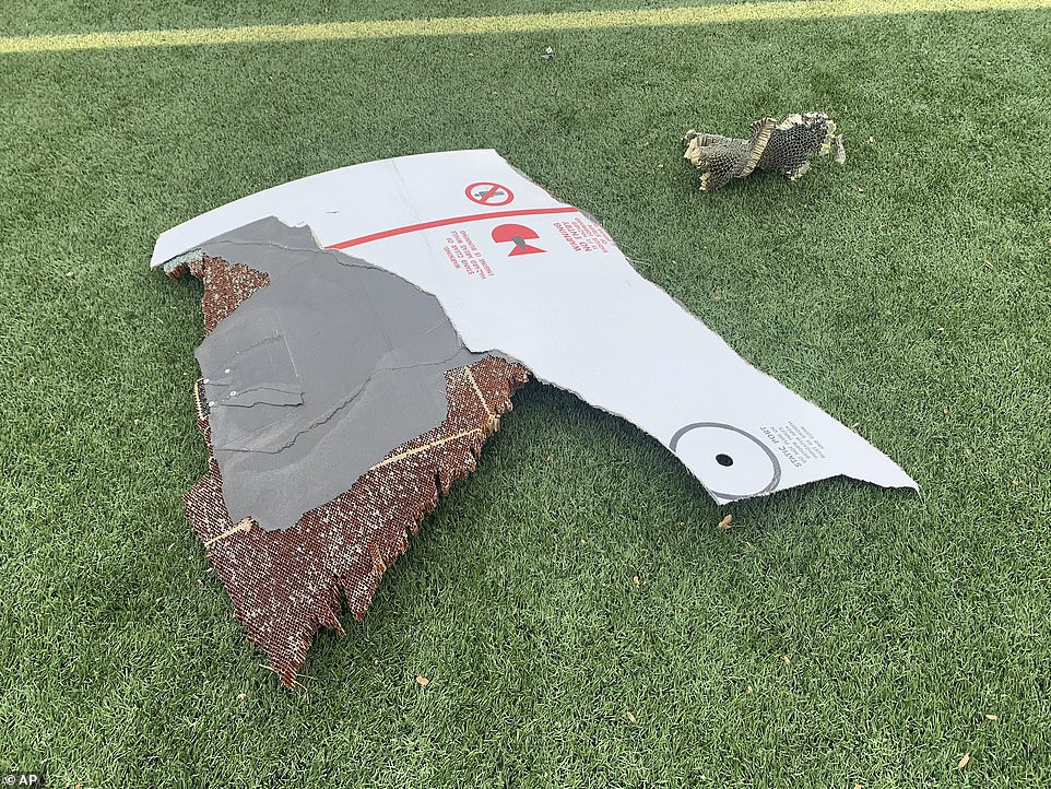 39559258-9282215-More_debris_is_seen_above_on_a_turf_football_field_at_Commons_Pa-a-4_1613889288548.jpg